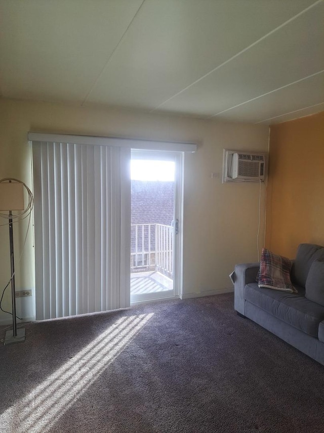 unfurnished living room featuring a wall mounted AC and carpet