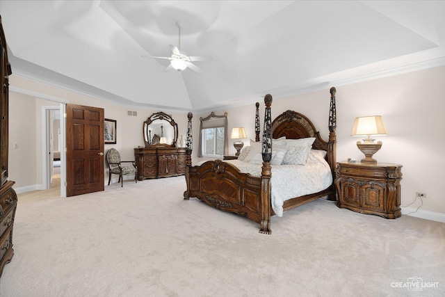 carpeted bedroom featuring ceiling fan, crown molding, and a tray ceiling