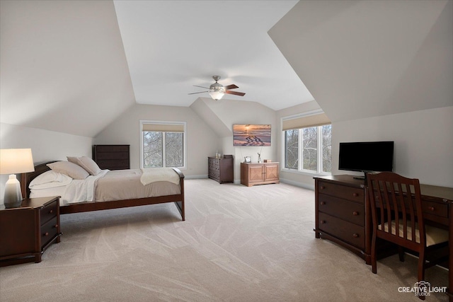 carpeted bedroom with ceiling fan and vaulted ceiling