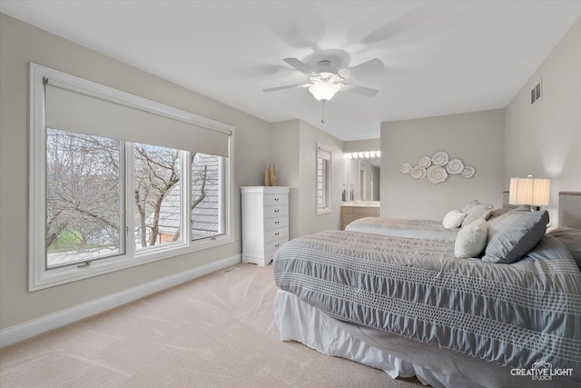 bedroom featuring ceiling fan, ensuite bathroom, and carpet flooring