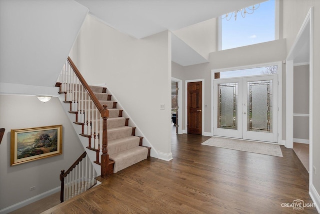 foyer featuring a high ceiling, french doors, and dark hardwood / wood-style flooring