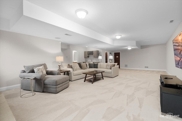 living room with bar area and light colored carpet