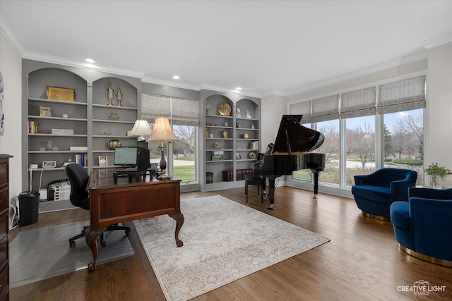 office space with ornamental molding, built in features, and wood-type flooring