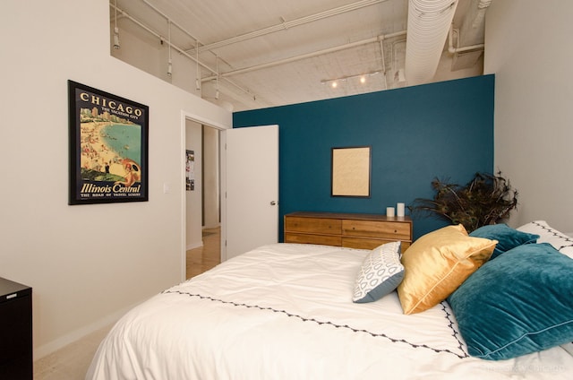 bedroom with carpet and rail lighting