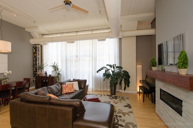 living room featuring ceiling fan and light hardwood / wood-style floors