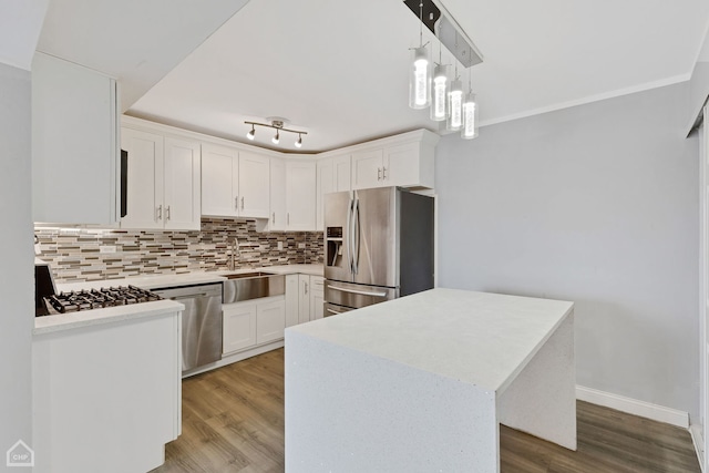 kitchen with a center island, stainless steel appliances, white cabinetry, and sink