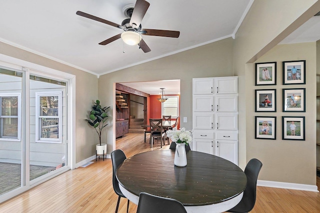 dining space featuring vaulted ceiling, ornamental molding, light hardwood / wood-style floors, and ceiling fan