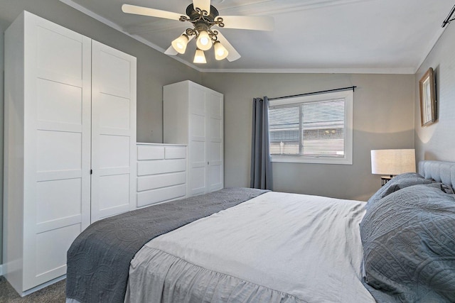 carpeted bedroom featuring ornamental molding, vaulted ceiling, and ceiling fan