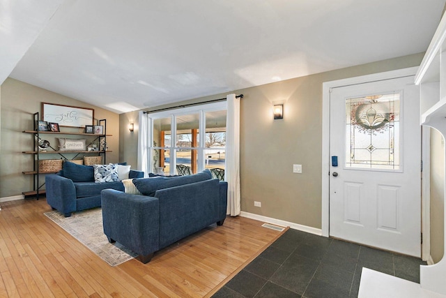 living room with lofted ceiling and hardwood / wood-style floors