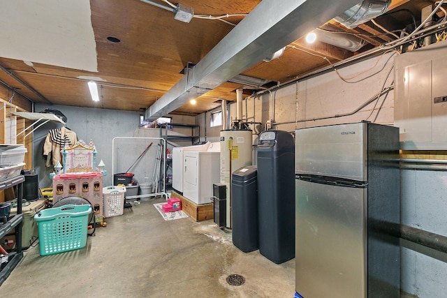 basement with electric panel, stainless steel refrigerator, and washing machine and clothes dryer