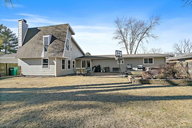 rear view of house featuring a yard and a patio