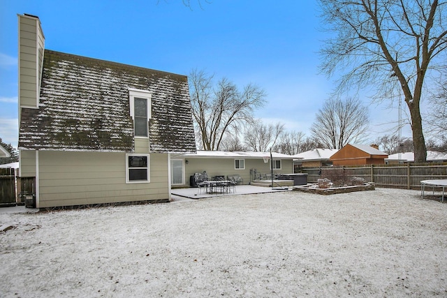 back of property featuring a patio and a trampoline