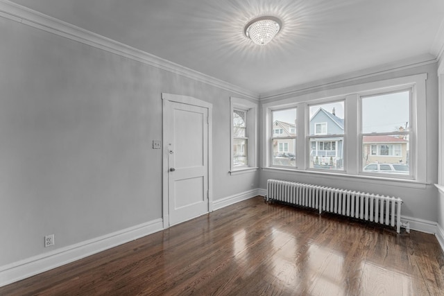 unfurnished room with dark hardwood / wood-style flooring, crown molding, and radiator heating unit