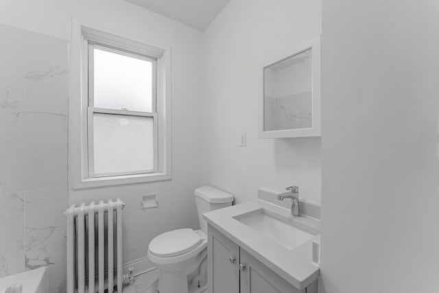 bathroom with vanity, toilet, and radiator heating unit