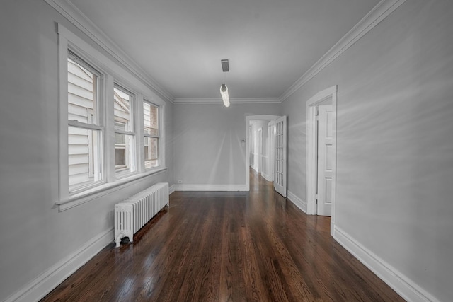 unfurnished dining area with dark hardwood / wood-style floors, ornamental molding, and radiator