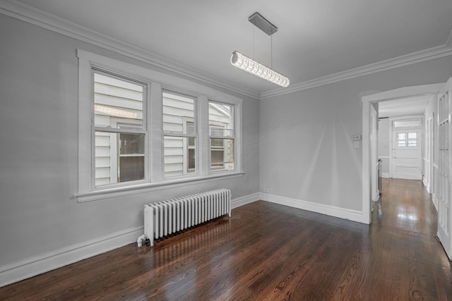 unfurnished room featuring crown molding, radiator, and dark wood-type flooring