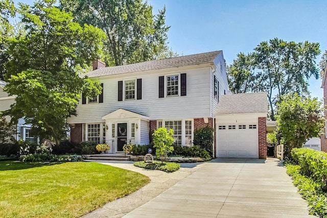 colonial home featuring a front yard and a garage