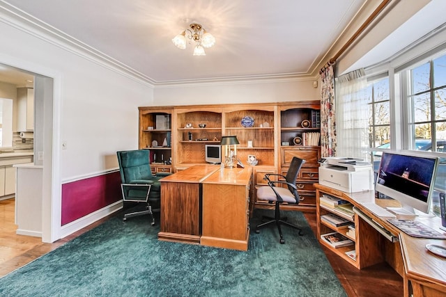 office area with a chandelier, crown molding, and dark colored carpet