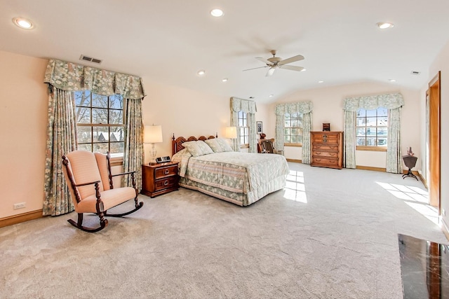 bedroom with vaulted ceiling, light colored carpet, and ceiling fan