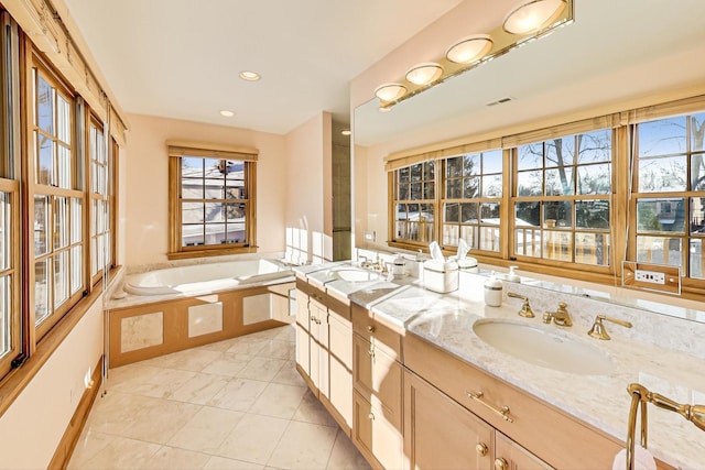 bathroom featuring a bath, tile patterned floors, and vanity