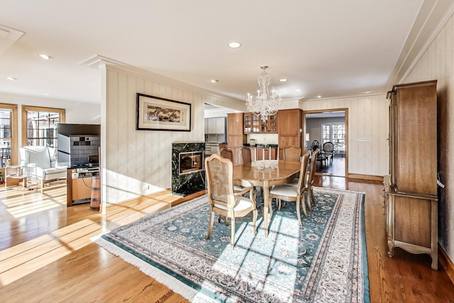 dining room featuring a notable chandelier, crown molding, and hardwood / wood-style flooring