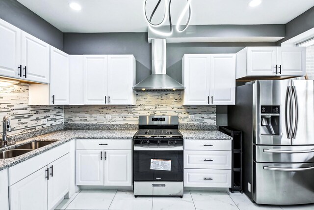 kitchen with white cabinetry, sink, wall chimney range hood, stone countertops, and appliances with stainless steel finishes