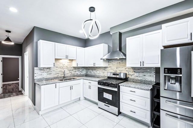 kitchen featuring pendant lighting, wall chimney range hood, sink, light stone countertops, and stainless steel appliances