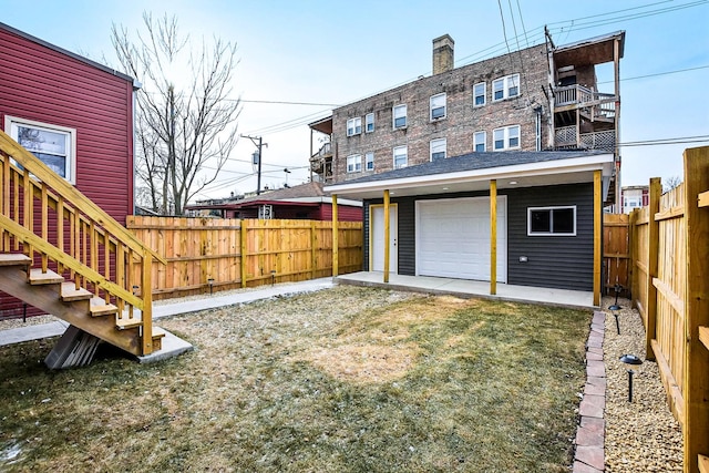 view of yard featuring a garage and an outbuilding