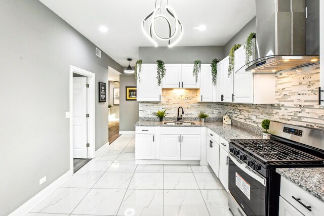 kitchen with white cabinetry, stainless steel gas range oven, wall chimney exhaust hood, and sink