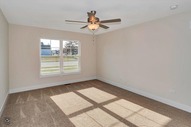 carpeted empty room featuring ceiling fan