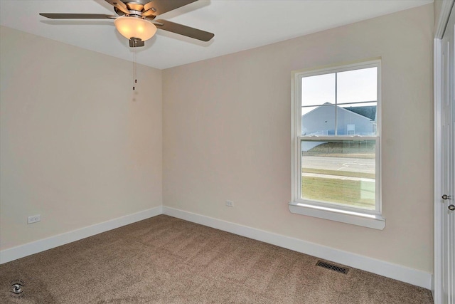 carpeted spare room featuring ceiling fan