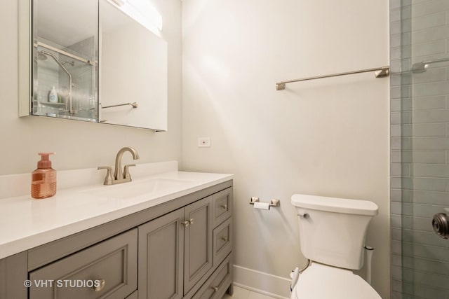 bathroom with vanity, toilet, and walk in shower