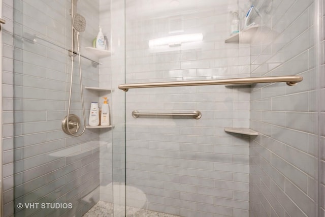 bathroom featuring a shower with door