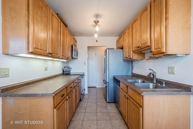 kitchen with light tile patterned floors, sink, and appliances with stainless steel finishes