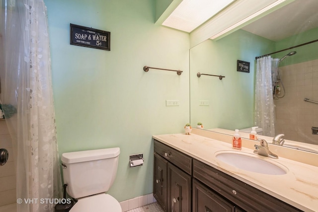 bathroom with tile patterned floors, vanity, toilet, and walk in shower