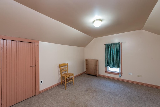 bonus room with radiator, light colored carpet, and lofted ceiling