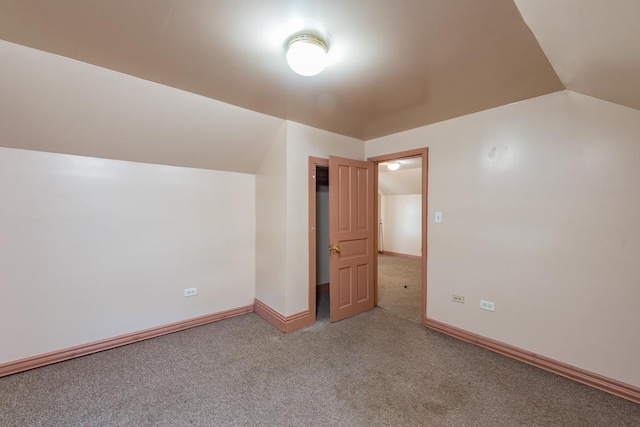 bonus room with carpet floors and lofted ceiling