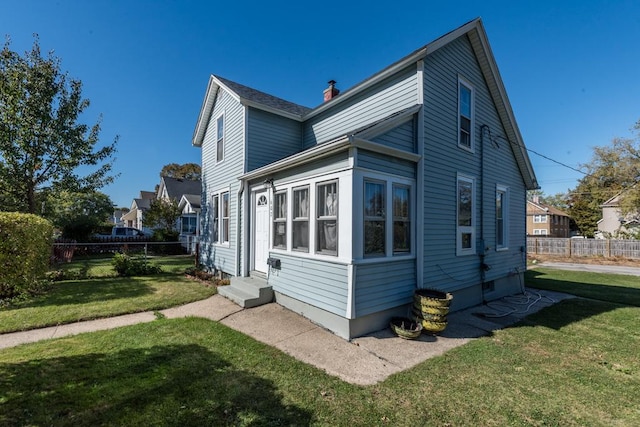 view of side of property featuring a yard