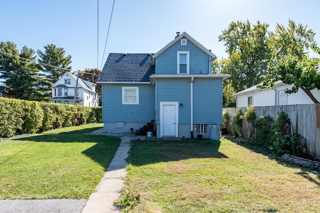 rear view of property with a lawn