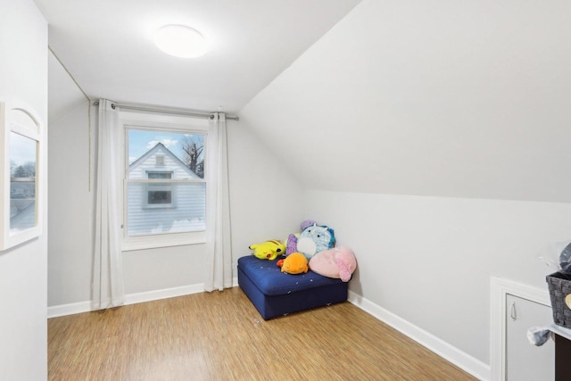 interior space with lofted ceiling and light wood-type flooring