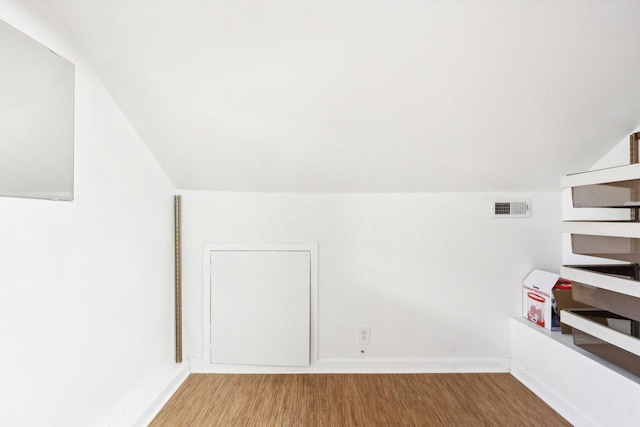 bonus room with lofted ceiling and hardwood / wood-style floors