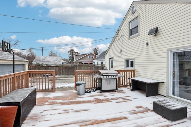 snow covered deck featuring a grill