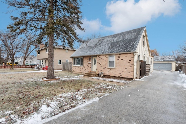 view of front of house with a garage and an outdoor structure