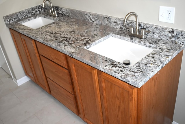 bathroom with tile patterned floors and vanity