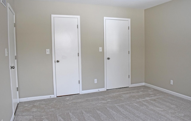 unfurnished bedroom with light carpet