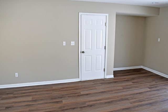 unfurnished room featuring dark wood-type flooring