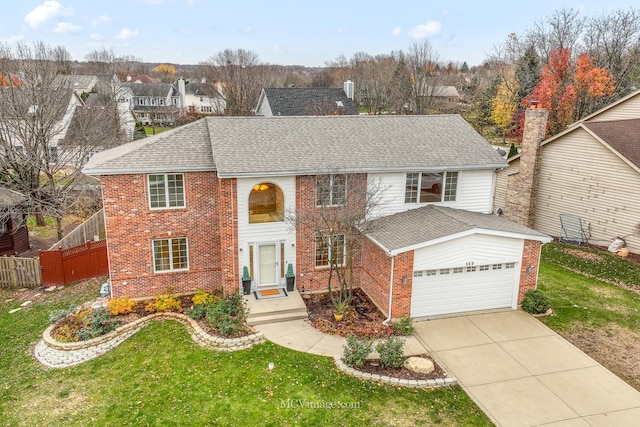 view of property with a front yard and a garage