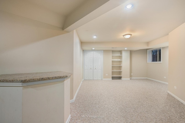 basement featuring light carpet