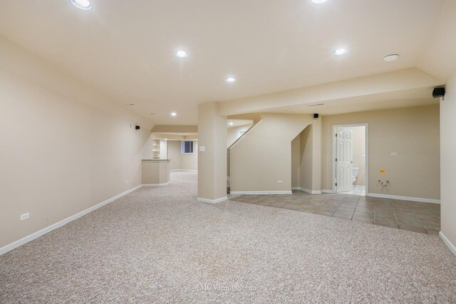 unfurnished living room with light colored carpet