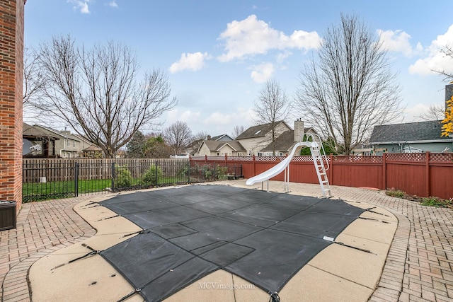 view of swimming pool featuring a patio area and a water slide